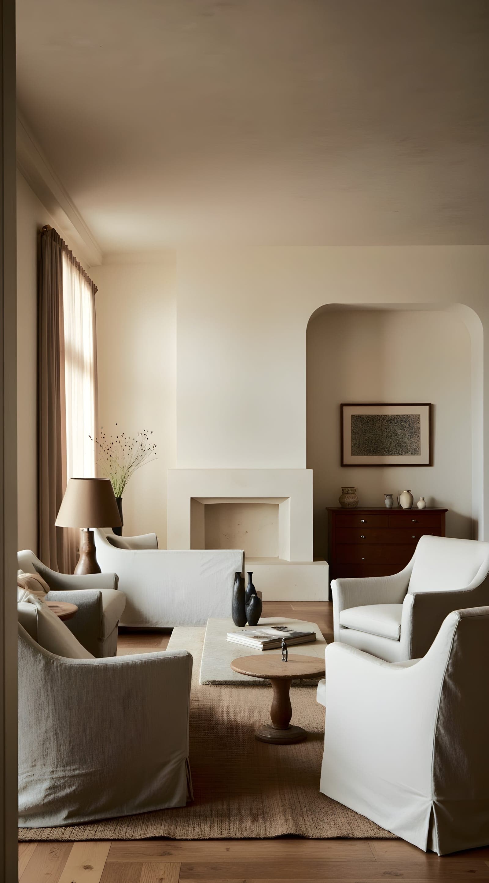 An arched passage through a kitchen to a sunlit dining room